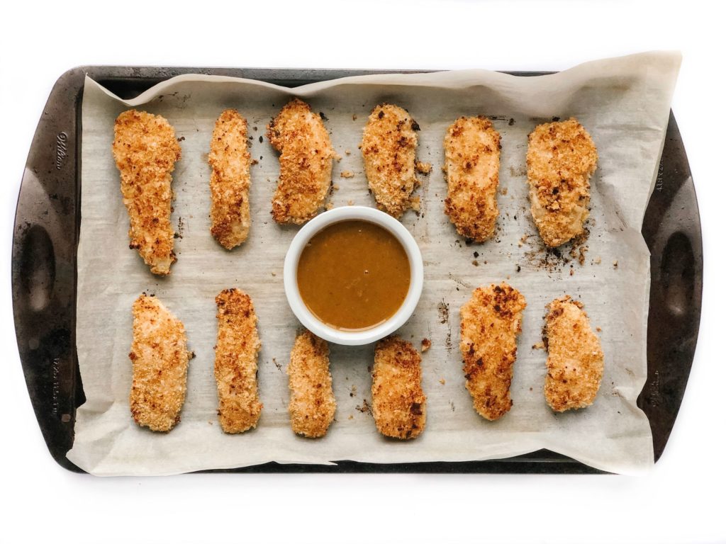 5 meals that make dinner time with your toddler less stressful - quinoa chicken strips with dipping sauce on a sheet pan