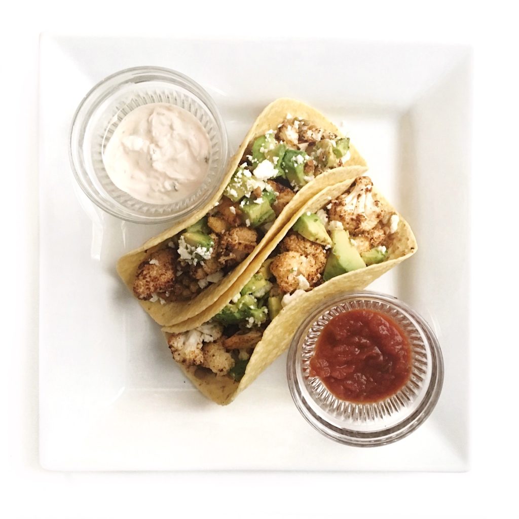 healthy weeknight recipes using cauliflower -  - toasted cauliflower lentil tacos on a plate with Greek yogurt and salsa