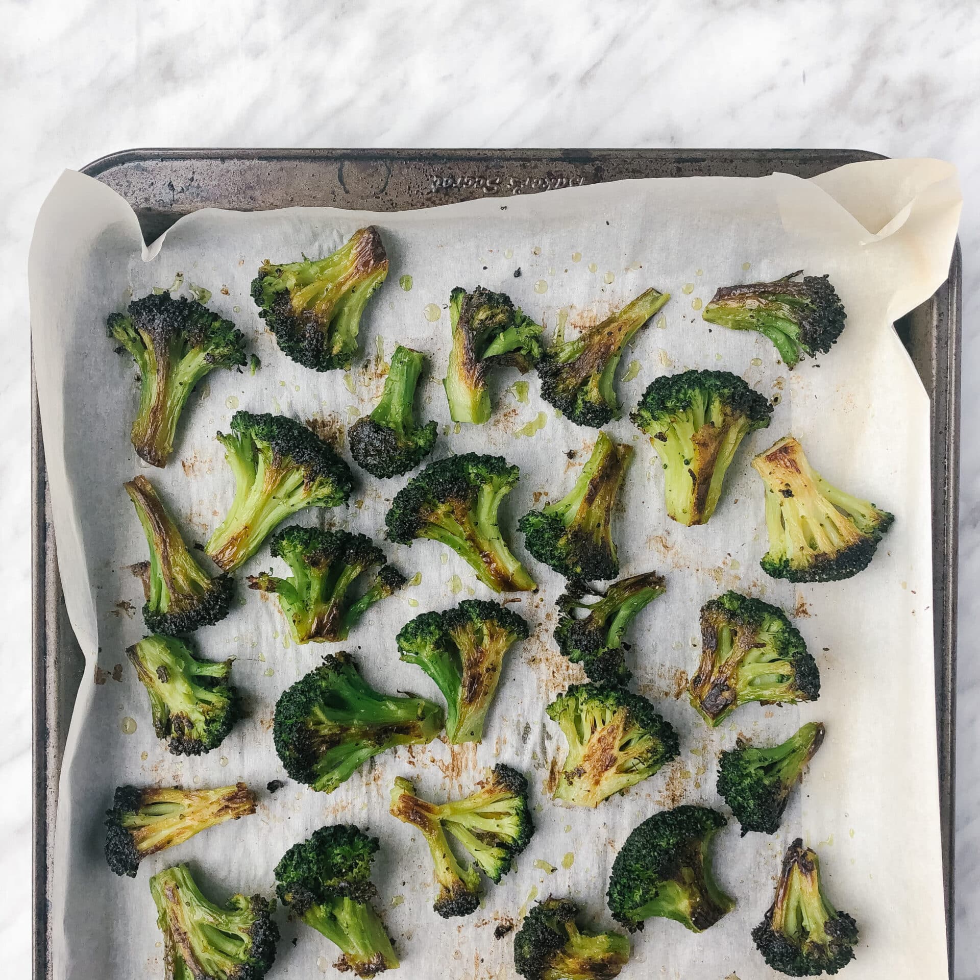 Crispy roasted frozen broccoli on a sheet pan