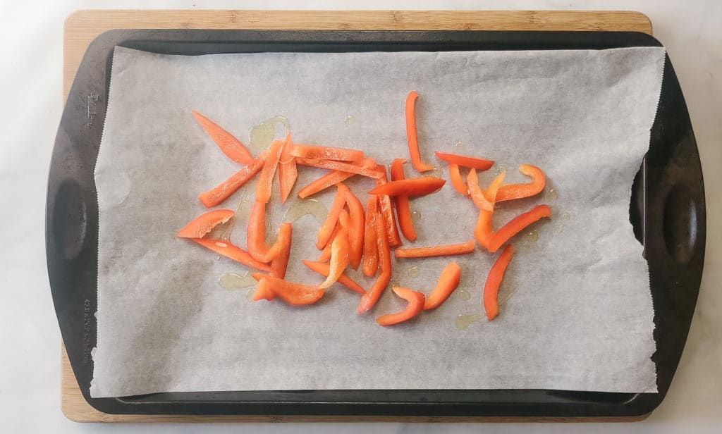 red bell pepper slices on a sheet pan 