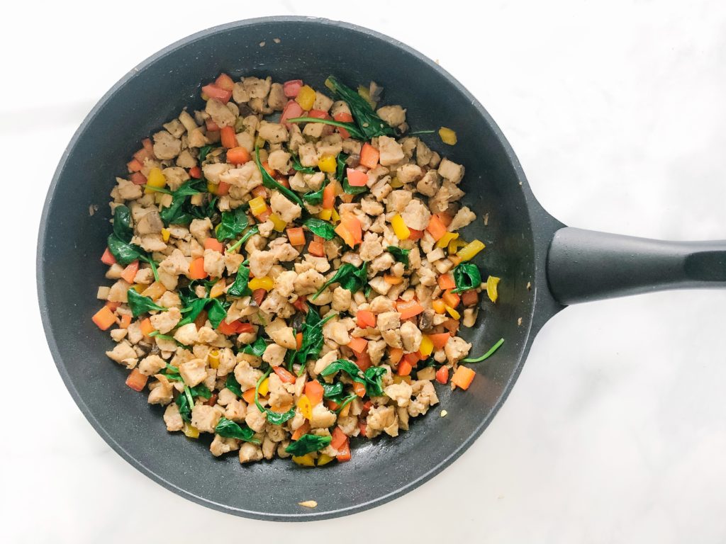 cooked chicken sausage, bell pepper, mushrooms, spinach in a pan