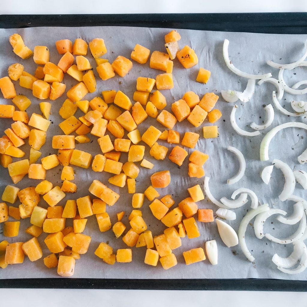 Butternut squash, onion and garlic on a sheet pan