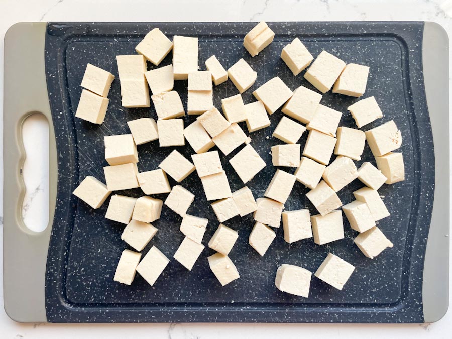 Easy honey garlic tofu - cut tofu on cutting board